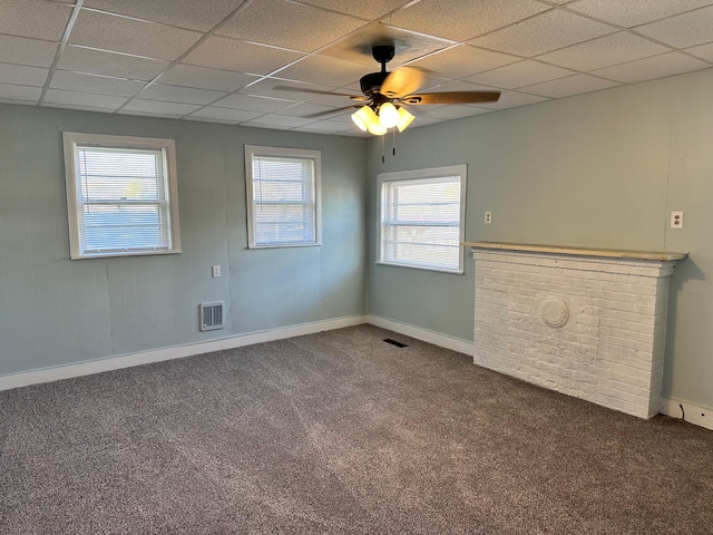 carpeted spare room featuring a paneled ceiling and ceiling fan