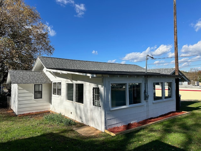 back of property with a lawn