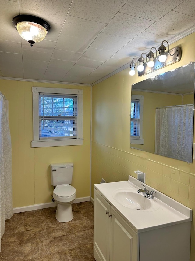 bathroom featuring decorative backsplash, vanity, toilet, and ornamental molding