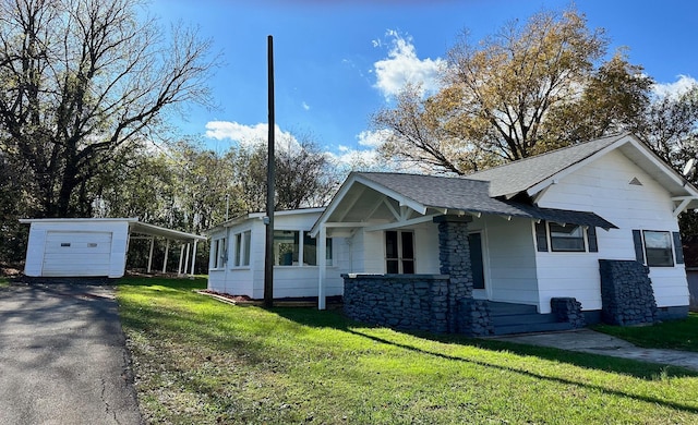 view of side of property with a carport and a yard