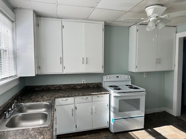 kitchen with white cabinets, electric stove, and sink