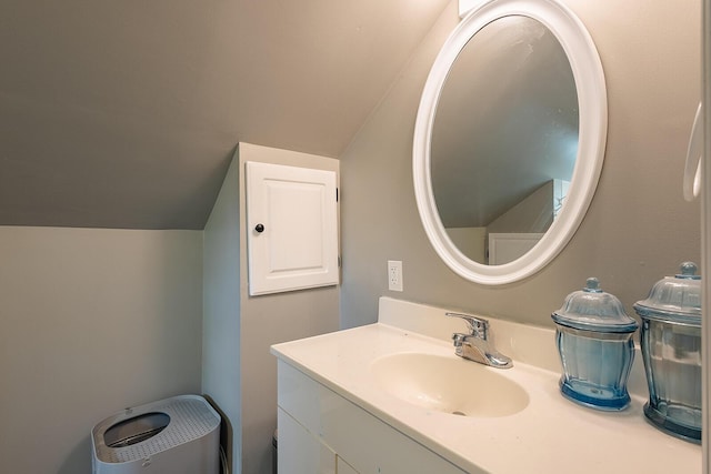 bathroom with vaulted ceiling and vanity