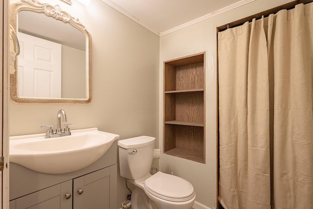 bathroom featuring crown molding, toilet, and vanity
