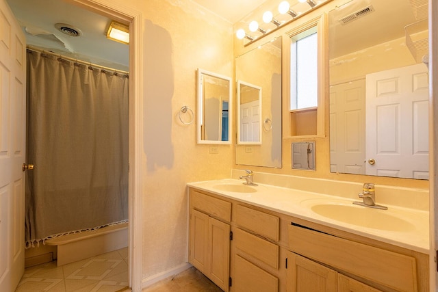 full bath with double vanity, a shower with curtain, and tile patterned flooring