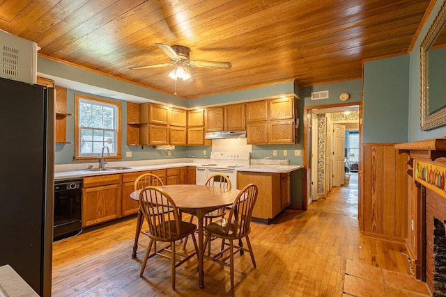 kitchen featuring a sink, freestanding refrigerator, black dishwasher, under cabinet range hood, and white electric range oven