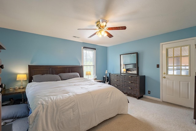 bedroom featuring light colored carpet, baseboards, and ceiling fan