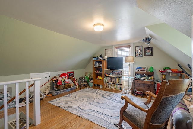 bonus room with wood finished floors and vaulted ceiling