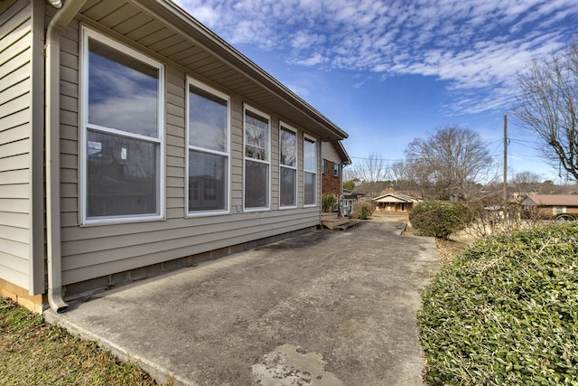 view of side of property with a patio area