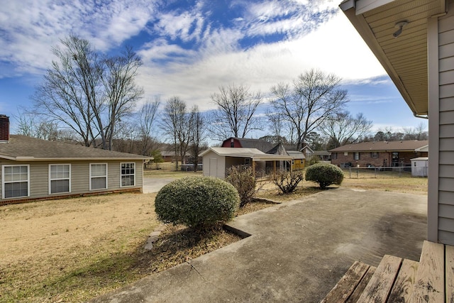 view of yard featuring fence and an outdoor structure