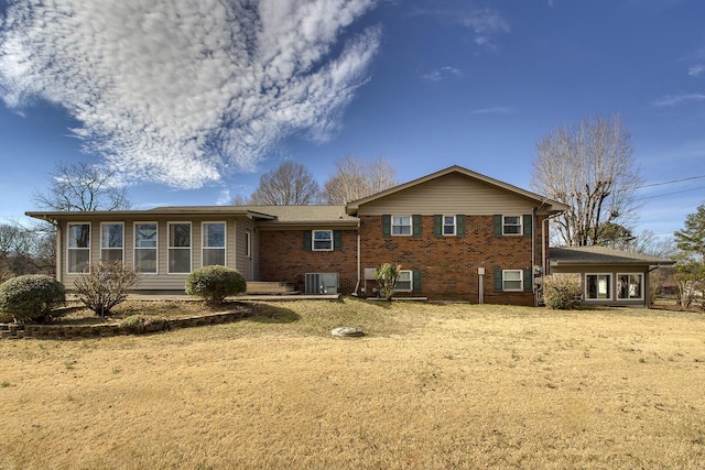 rear view of property with brick siding and central air condition unit