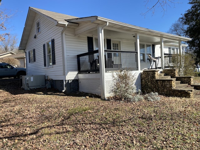 view of home's exterior with cooling unit and a porch