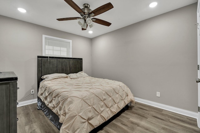 bedroom with baseboards, wood finished floors, recessed lighting, and a ceiling fan