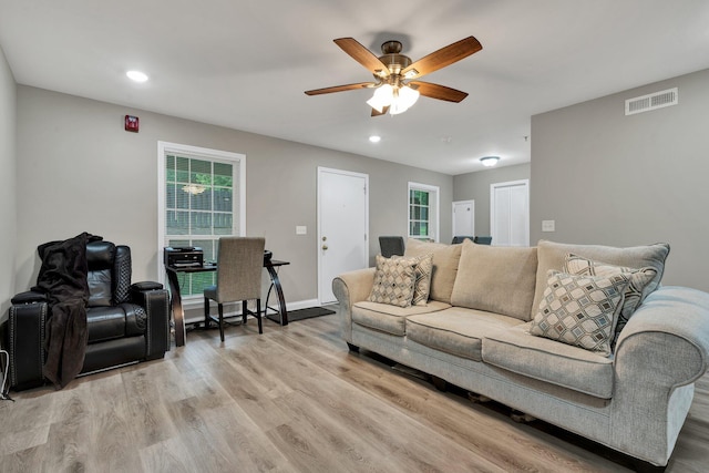 living room featuring a ceiling fan, light wood finished floors, plenty of natural light, and recessed lighting