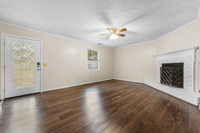 unfurnished living room with dark wood-type flooring, a fireplace, and crown molding