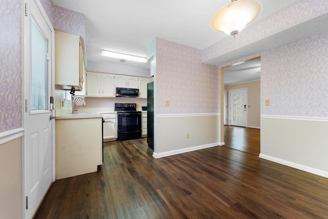 kitchen with white cabinetry, sink, dark wood-type flooring, and black appliances