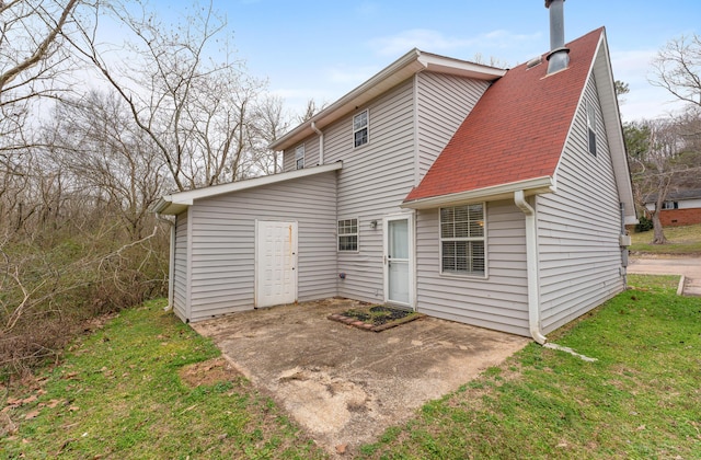 rear view of house with a yard and a patio area