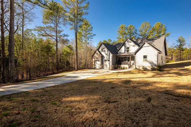 view of front of house with a front lawn, a porch, and a garage