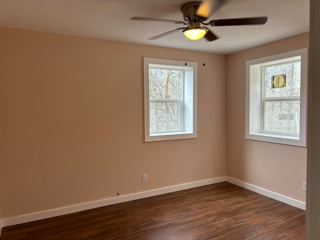 empty room with dark hardwood / wood-style flooring and ceiling fan