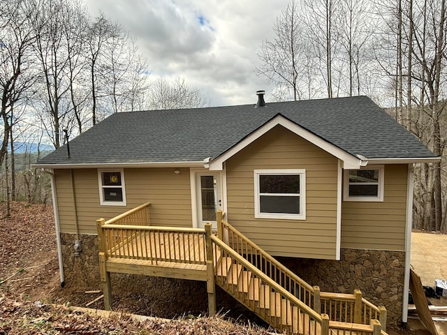 rear view of property with a wooden deck