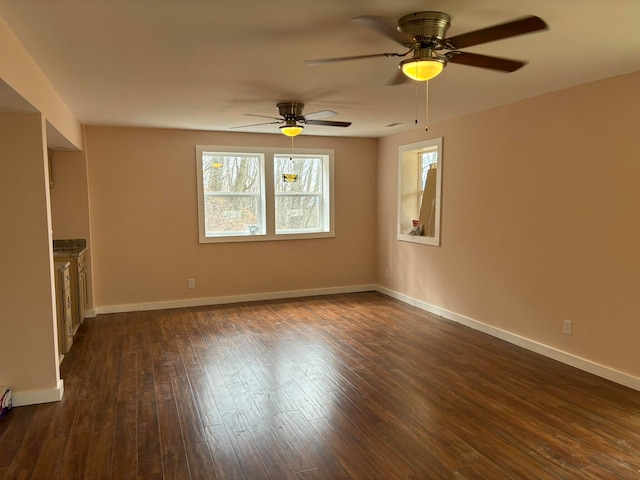 spare room with ceiling fan and dark hardwood / wood-style floors