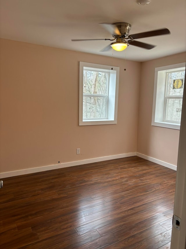 spare room featuring dark hardwood / wood-style flooring and ceiling fan