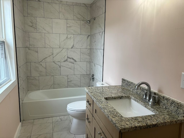 full bathroom featuring vanity, toilet, and tiled shower / bath