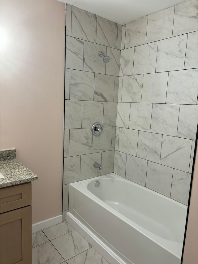 bathroom featuring vanity and tiled shower / bath