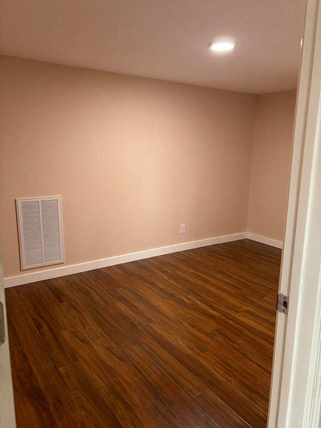 unfurnished room with dark hardwood / wood-style floors