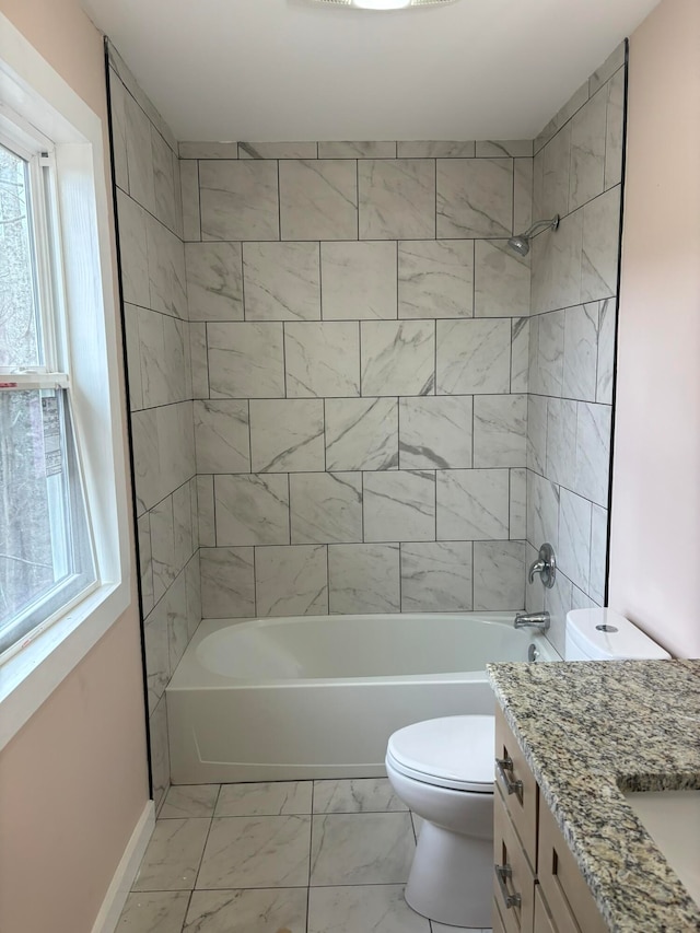 full bathroom featuring vanity, toilet, and tiled shower / bath