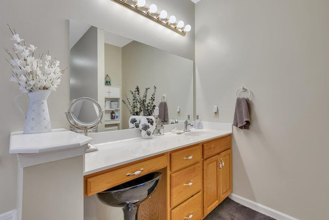 bathroom with vanity and baseboards