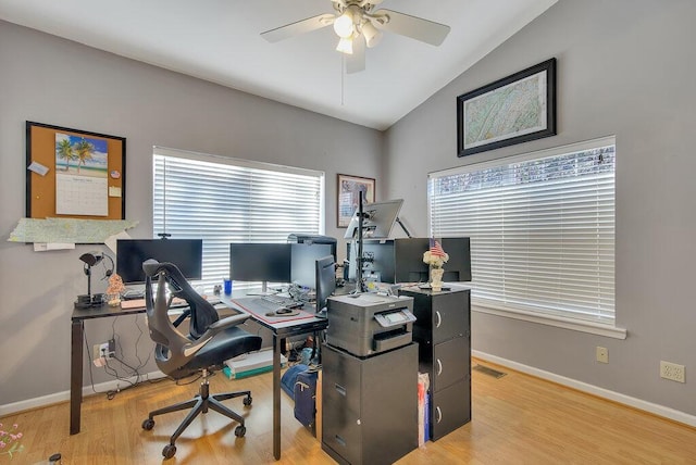 office space with ceiling fan, wood finished floors, visible vents, baseboards, and vaulted ceiling