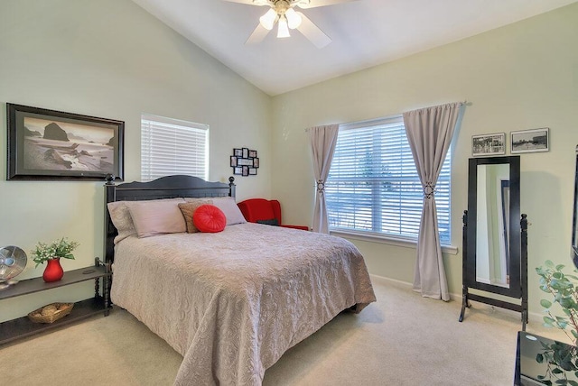 bedroom with lofted ceiling, ceiling fan, baseboards, and light colored carpet