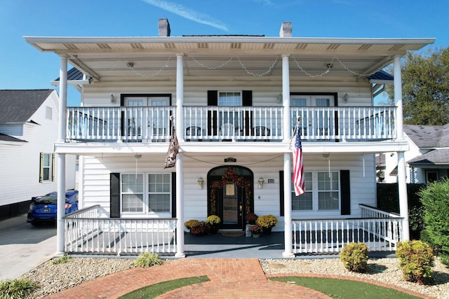 view of front of house with a porch and a balcony