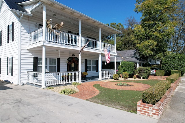 view of front of property with a balcony and a porch