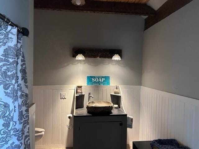 bathroom with radiator, wood ceiling, vanity, and beamed ceiling