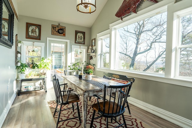 sunroom / solarium featuring vaulted ceiling