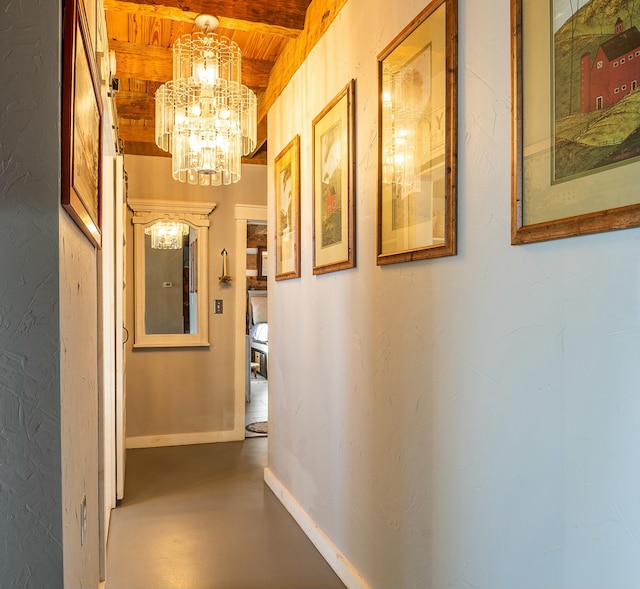 hall featuring beamed ceiling, a chandelier, and wooden ceiling