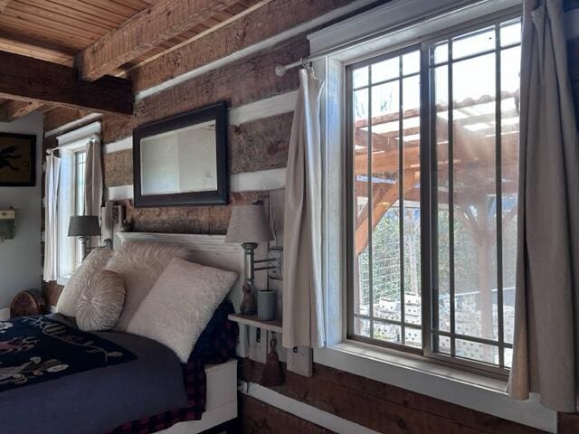 bedroom featuring wooden ceiling and beamed ceiling