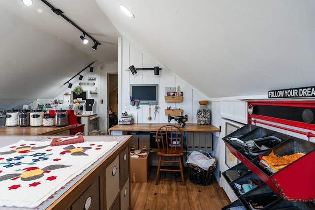 kitchen with vaulted ceiling and dark hardwood / wood-style flooring