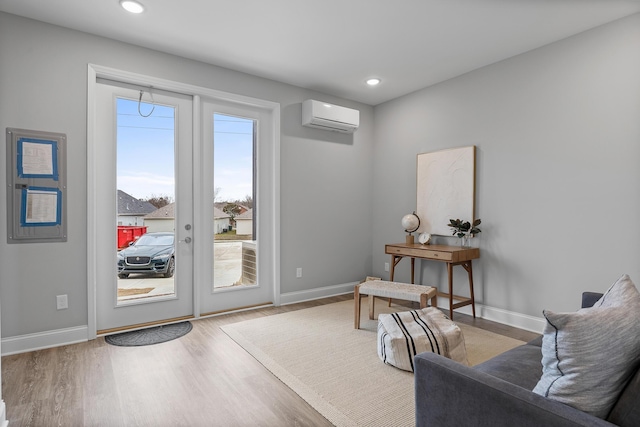 entryway with a wall unit AC and light hardwood / wood-style floors