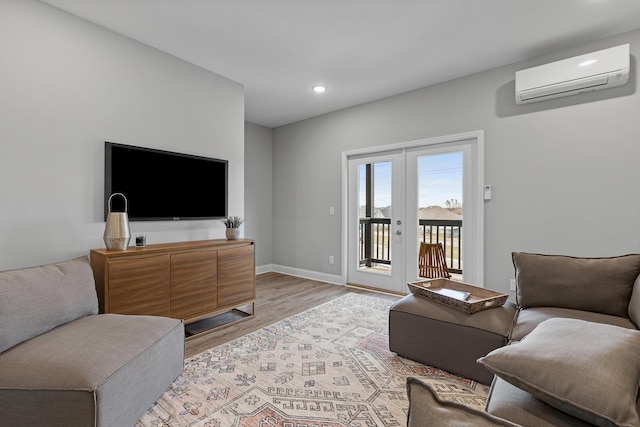 living room with light wood-type flooring and a wall unit AC