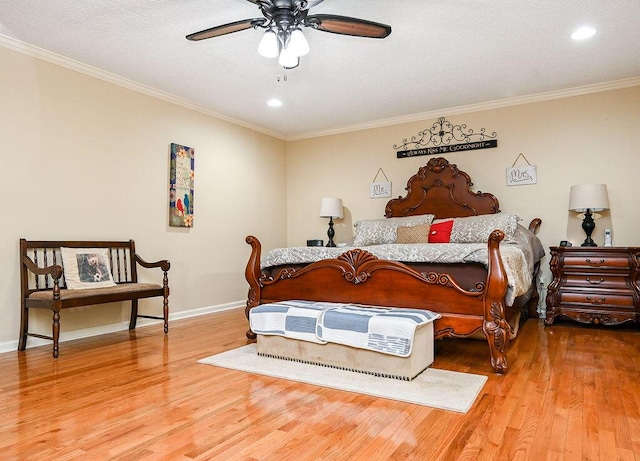 bedroom featuring hardwood / wood-style flooring, ceiling fan, ornamental molding, and a textured ceiling