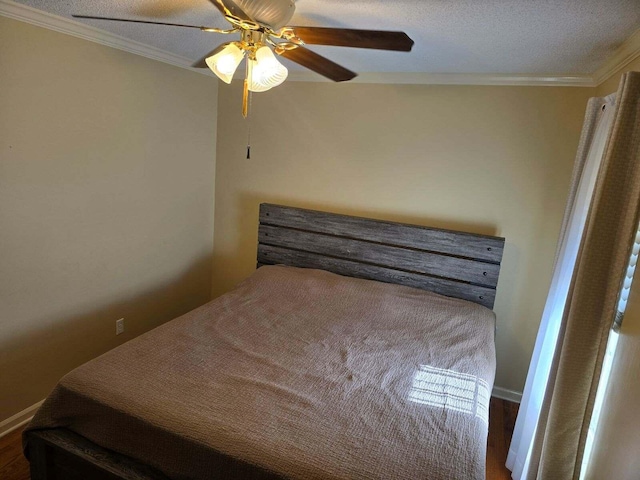 bedroom with a textured ceiling, ceiling fan, and ornamental molding