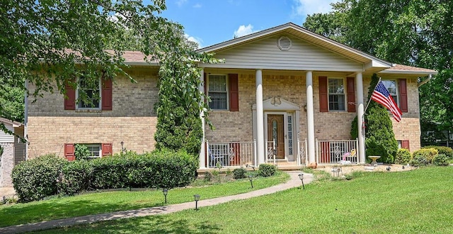 view of front of house with a porch and a front lawn