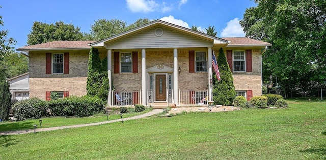 split foyer home with covered porch and a front lawn