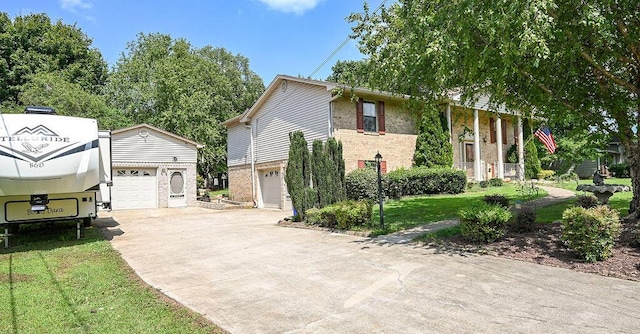 view of front of home with a front yard and a garage