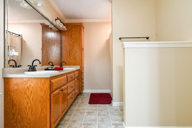 bathroom with crown molding, vanity, and a textured ceiling