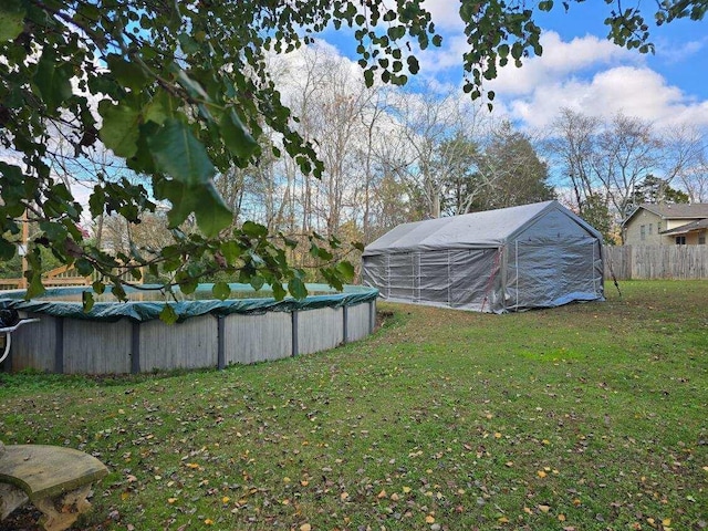 view of yard with a covered pool