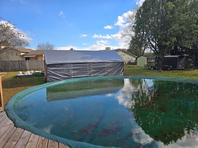 view of swimming pool with a storage unit