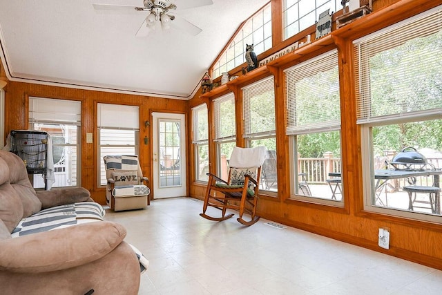 sunroom with ceiling fan and vaulted ceiling